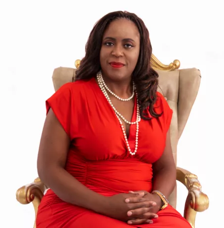 Beautiful woman wearing a red dress and pearl necklace; career success, professional Black woman, empower, work life balance, holistic happiness, build confidence, why I changed careers, reasons to change careers.