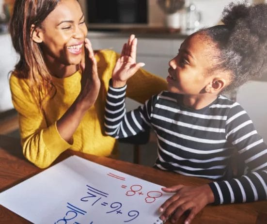 A Black woman giving her young child a high five;
how to build confidence for a job interview, career guidance,
how to boost confidence in public speaking, Twanna Carter,
how to improve confidence in relationships,
how to overcome social anxiety and gain confidence
