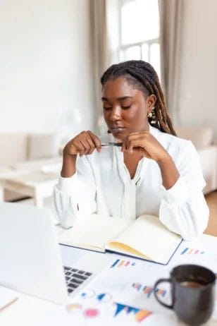 African American woman sit at workplace desk looks at laptop screen; feels concerned. Bored; reasons for a job change,
reasons to change job,
reasons for change job,
reasons for changing the job,
reasons for change of job,
reasons for change in job; 